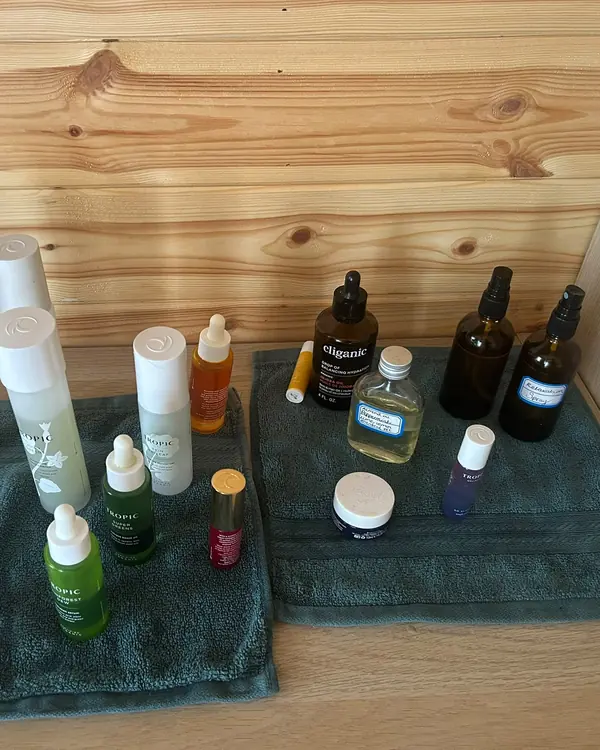 Noubalm serums, oils and creams laid out on folded towels